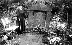 Woman mourning at grave, cemetery