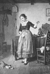 Woman playing with a ball of wool with a cat