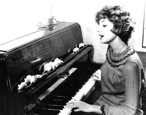 Woman playing piano for white mice