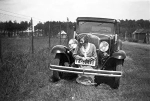 Woman posing in front of a car
