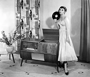 Woman posing next to a record player