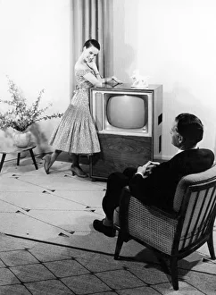Woman posing in front of a TV set