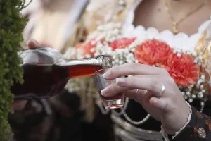 Woman pouring a shot of brandy