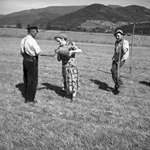Woman pouring water into a field worker