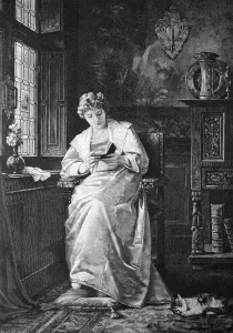 Woman reading a book at the window