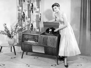 Woman in front of a record player in the living room