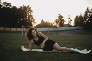 A woman relaxes on a yoga mat at sunset