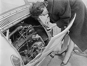 Woman repairing a car, 1960s, Germany, Europe