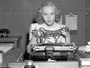 Woman, secretary, desperate on typewriter
