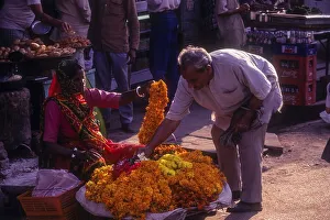 A woman selling mari gold flowers at Varanasi Benaras