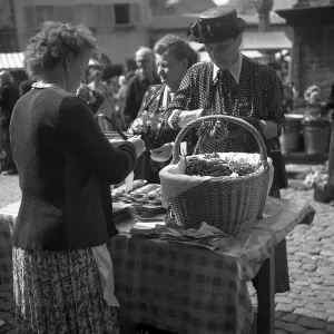 Woman selling pretzels at a market