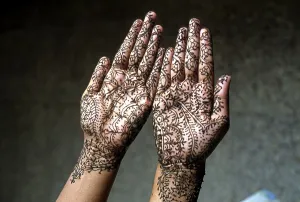 A woman showing mehandi henna applied hands
