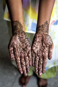 A woman showing mehandi henna applied hands
