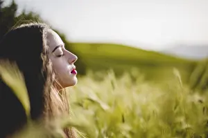 Woman sitting meditating grass