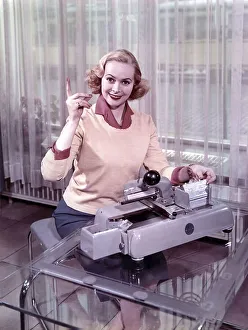 Woman sitting in front of a typewriter