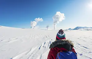 Woman standing in snow, rising steam