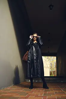A woman stands in a narrow hallway