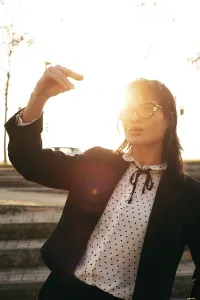 A woman in sunglasses and a polka dot blouse
