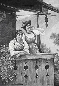 Two woman in traditional dress standing on a balcony