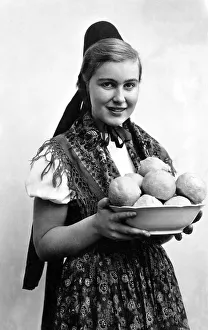 Woman in traditional traditional costume with dumplings