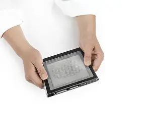 Woman using Sony Reader. PRS-700 Portable Reader System