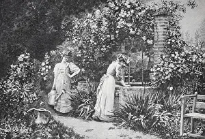 Two woman working in a flowery garden at a fountain