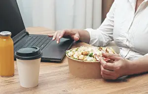 A woman is working on a laptop at home