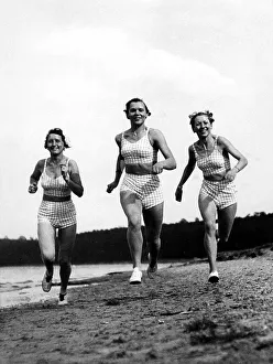 Three women jogging on the beach