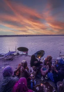 Women offering ritual prayers on the steps of the Ganga Ganges ghat at Varanasi Benaras