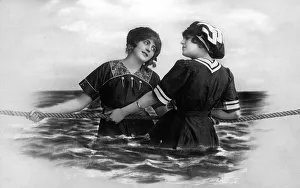 Two women pulling a rope in the sea