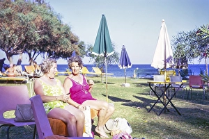 Two women sitting sunbathing in hotel garden, Cyprus, Europe 1973, Europe