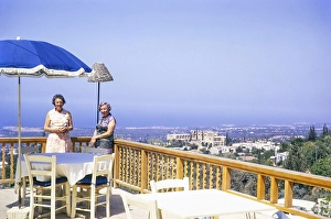 Two women standing on restaurant terrace view over Bellapais Abbey, Kyrenia or Girne, Northern Cyprus, Cyprus, Europe 1973, Europe