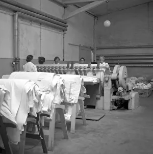 Women working on a warp weaving machine around 1950