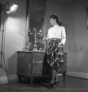 Women's fashion in the 1940s. A young woman photographed for a ladies magazine to show the women's fashion of 1945