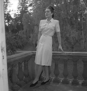 Women's fashion in the 1940s. A young woman photographed for a ladies magazine to show the women's fashion of 1945