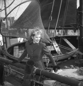 Women's fashion in the 1940s. A young woman in a typical 1940s jacket and skirt