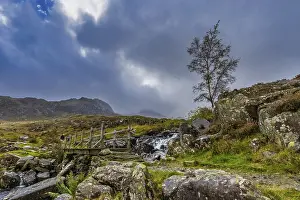 Wooden bridge leading to mountain's Snowdonia National Park