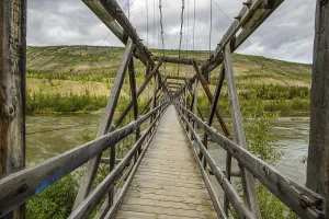The wooden bridge across the Pelly River that carried the historic Canol Pipeline from Norman Wells to Whitehorse