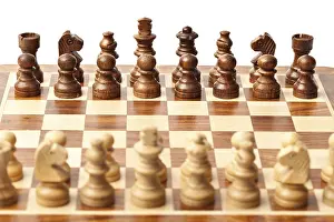 Wooden chess pieces on chessboard