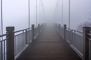 Wooden hanging bridge at Tianmen Mountain vanishing in very heavy mist