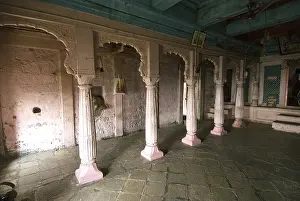 Wooden and pink pillars in temple at Shivneri fort