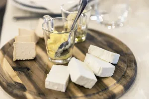Wooden plate with cheese and sauces