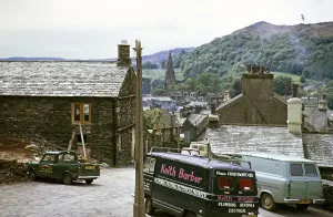 Work vehicles parked in the village of Ambleside, Lake District, Cumbria, England, UK 1973