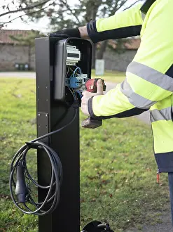 Worker installing an ev charging point