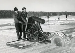 Workers collecting ice. Two men are sawing blocks of ice to use in homes to keep groceries cool
