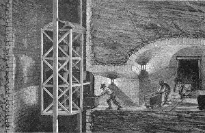 Workers in a mine, loading the dogs (transport carts) at the exit of the roadway