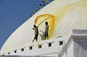 Workers renewing the yellow paint of Boudnath Stupa