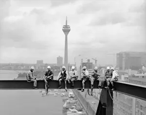 Workers sitting on a steel beam