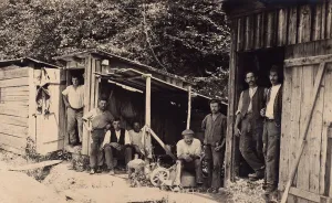 Workers in wooden sheds, historical photograph