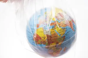 Category Historic EN Prints: World globe in plastic bag isolated on white background
